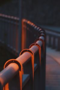 Close-up of empty chairs against railing