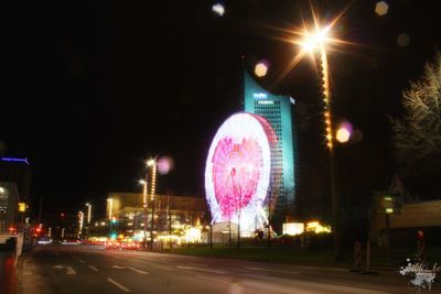 View of illuminated ferris wheel at night