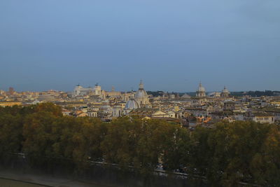 Buildings in city against clear sky