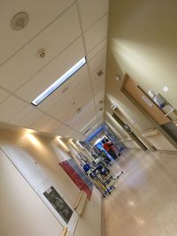 Low angle view of man standing on illuminated ceiling