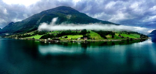 Scenic view of lake and mountains against sky