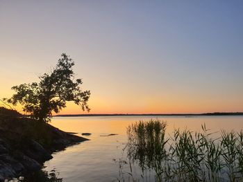 Scenic view of sea against clear sky during sunset