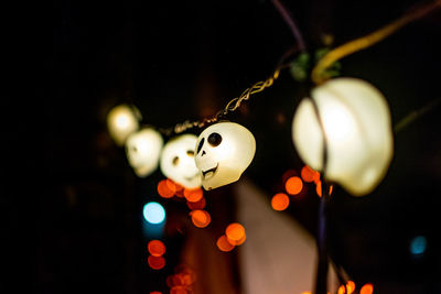 Low angle view of illuminated skull shaped lights at night