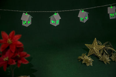 Close-up of multi colored flags hanging against black background