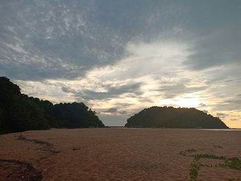 Scenic view of beach against sky during sunset