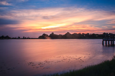 Scenic view of lake against sky during sunset