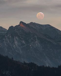 Scenic view of mountains against sky at dusk