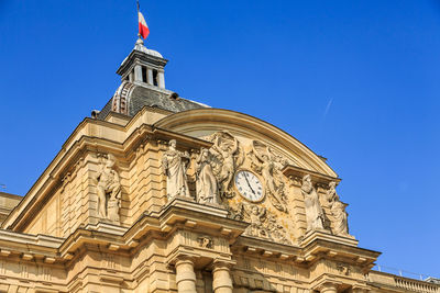 Low angle view of building against blue sky