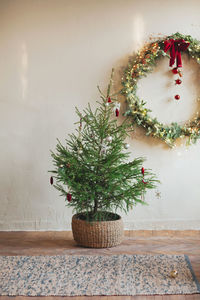 Close-up of christmas tree against wall at home