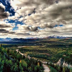 Scenic view of mountains against cloudy sky