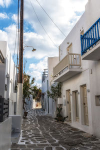 Street amidst houses against sky