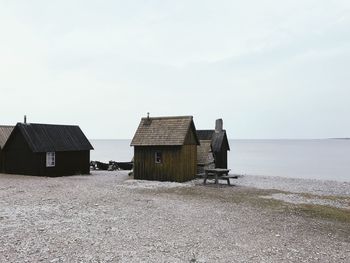 Houses at beach against sky