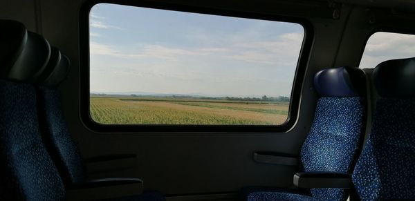 Field seen through car window