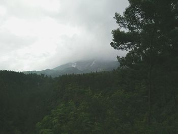 Scenic view of mountains against cloudy sky