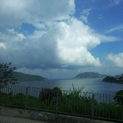 Scenic view of lake against cloudy sky