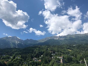Scenic view of green landscape and mountains against sky