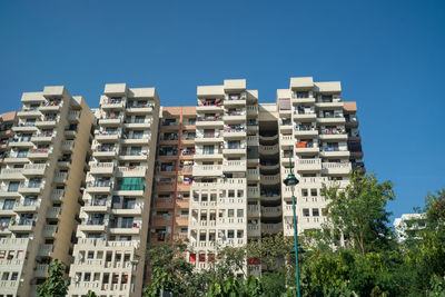 Low angle view of buildings against clear blue sky