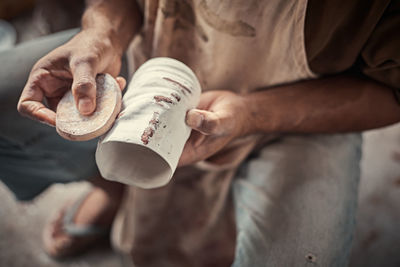 Midsection of potter potting pottery