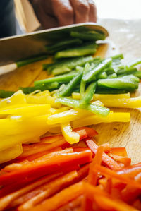 Close-up of person cutting bell peppers