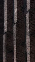 Low angle view of brick wall in city