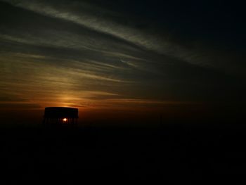 Silhouette of trees against sky at sunset