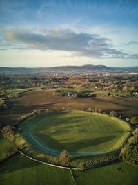 High angle view of golf course on field against sky