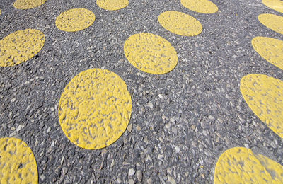 High angle view of yellow sign on road