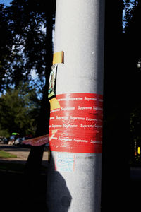 Close-up of road sign against trees