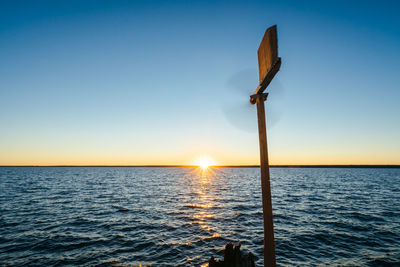 Scenic view of sea against clear sky during sunset