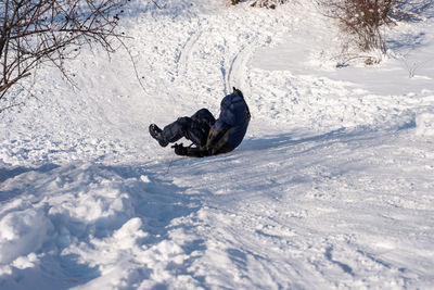 Rear view of person sliding on snow