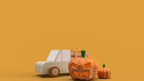 Close-up of toys on table against orange background