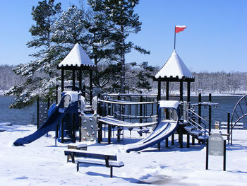 Built structure on snow covered park against sky