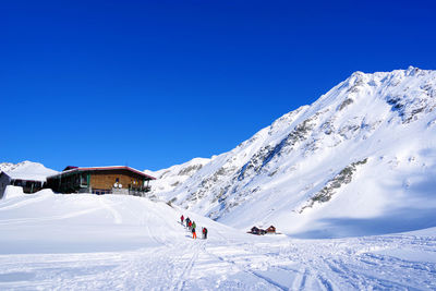 Scenic view of snowcapped mountains against clear blue sky