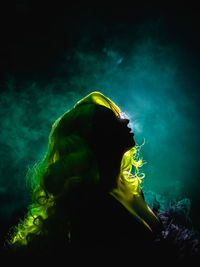 Boudoir showgirl with backlight and smoke