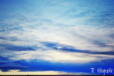 Low angle view of sign against sky at sunset