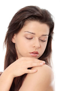 Close-up portrait of a young woman over white background