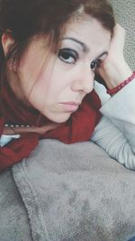 Portrait of woman lying on bed