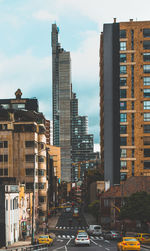 View of city street and buildings against sky