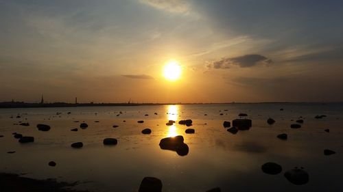 View of calm beach at sunset