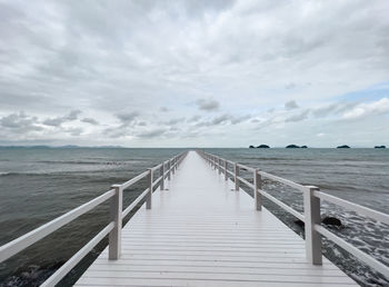 Pier over sea against sky