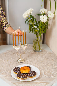 Midsection of woman holding christmas decoration on table