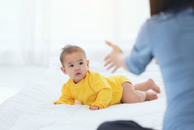 Boy lying on bed at home