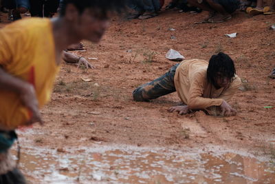 Man crawling on sand during halloween