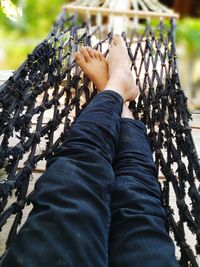 Low section of woman wearing shoes on land