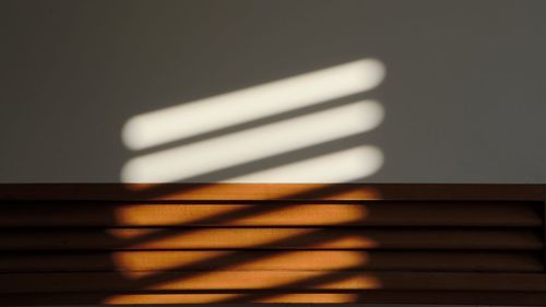 Close-up of pipes on table against wall