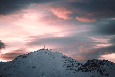 Snow covered mountain against sky during sunset