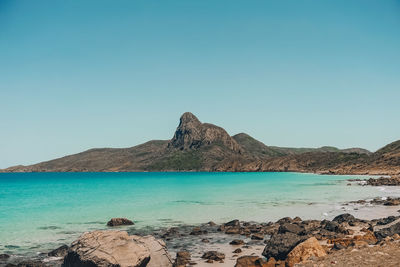 Scenic view of sea against clear blue sky