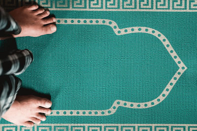 Low section of man standing on carpet