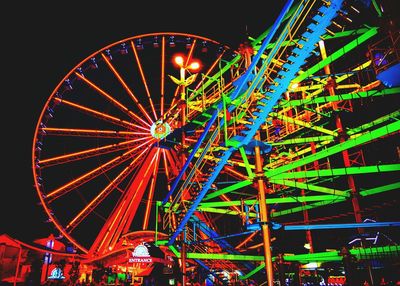 Low angle view of ferris wheel against sky at night