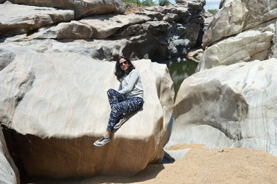 Young woman sitting on rock